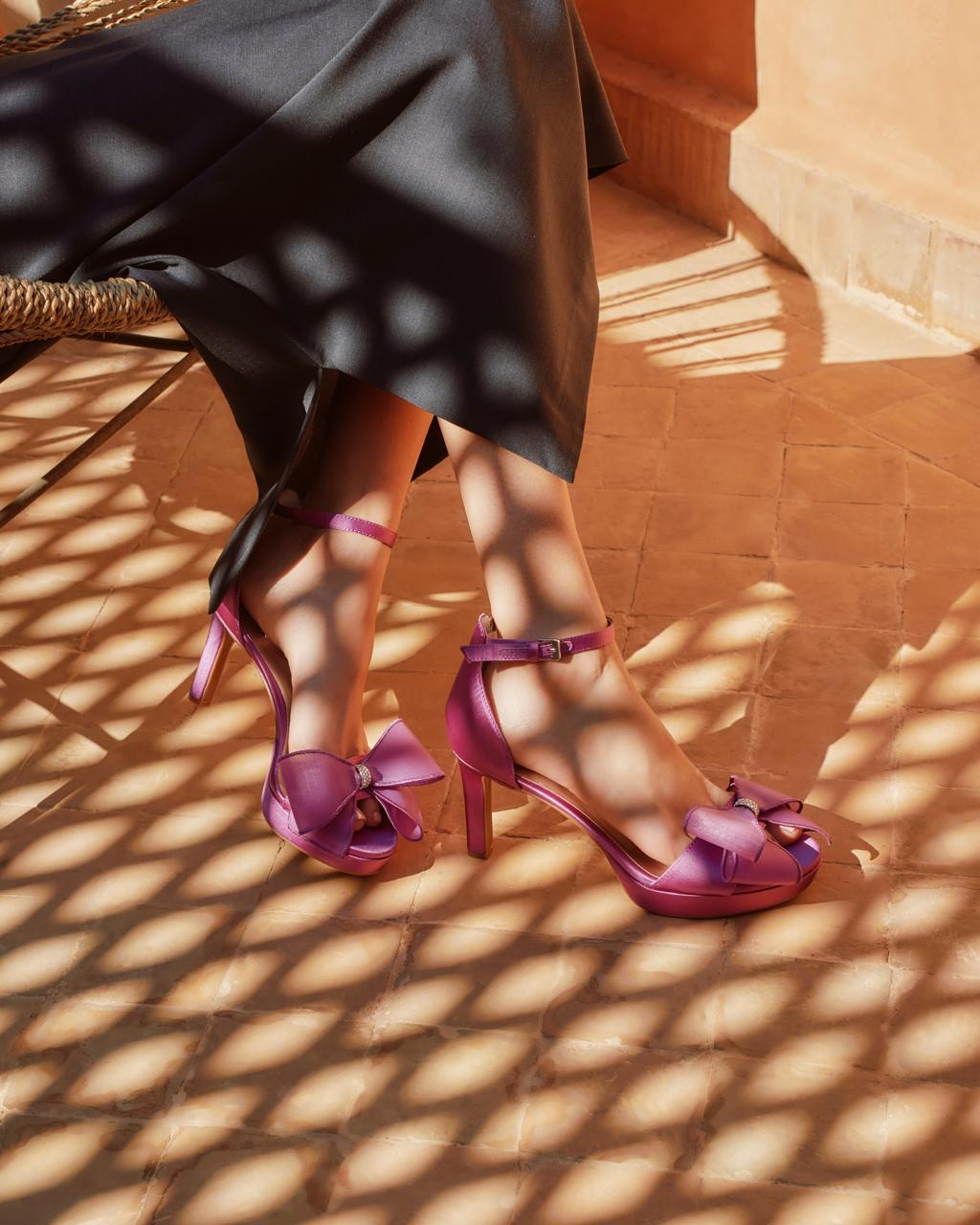 Fuchsia bow platform heels in patterned shadow